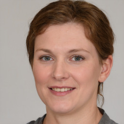 Joyful white young-adult female with medium  brown hair and blue eyes