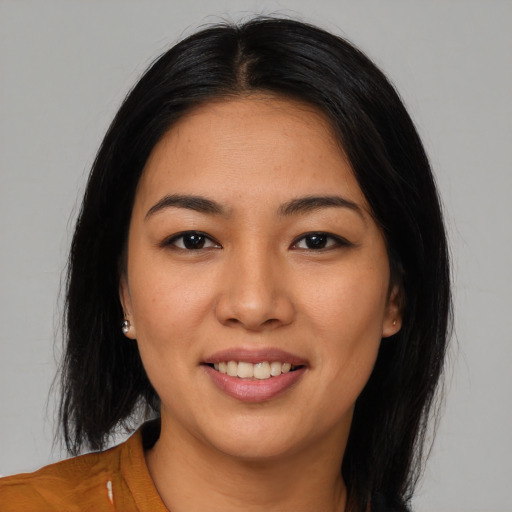 Joyful asian young-adult female with long  black hair and brown eyes