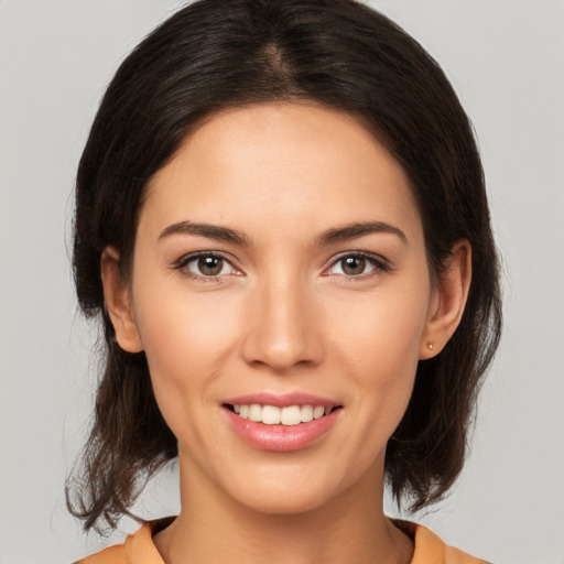 Joyful white young-adult female with medium  brown hair and brown eyes