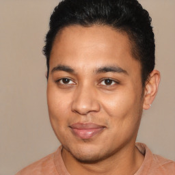 Joyful latino young-adult male with short  brown hair and brown eyes