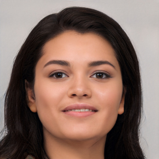 Joyful latino young-adult female with long  black hair and brown eyes