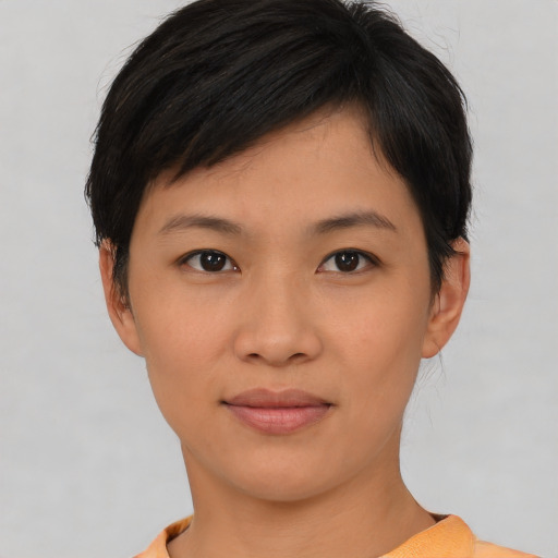 Joyful asian young-adult female with short  brown hair and brown eyes