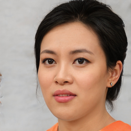Joyful asian young-adult female with medium  brown hair and brown eyes