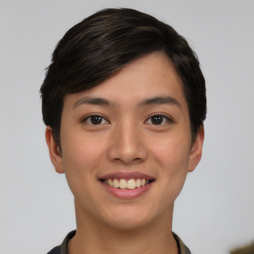 Joyful asian young-adult female with short  black hair and brown eyes