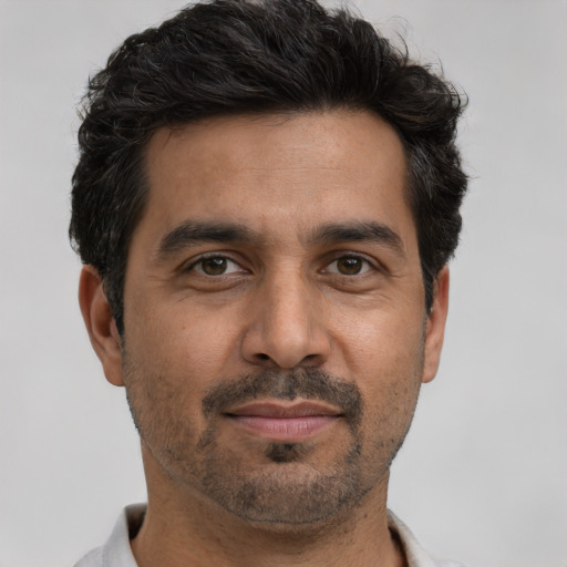 Joyful white adult male with short  black hair and brown eyes
