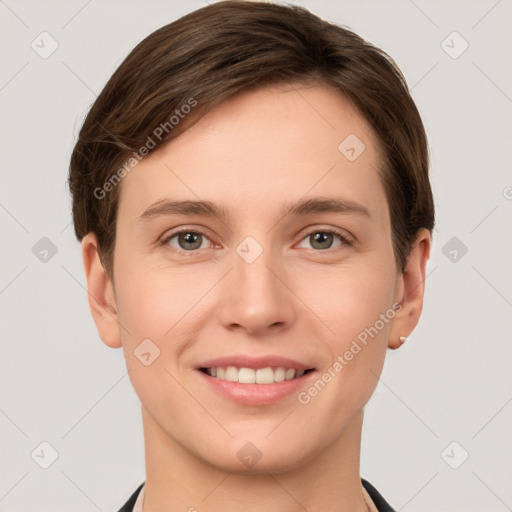 Joyful white young-adult female with short  brown hair and grey eyes