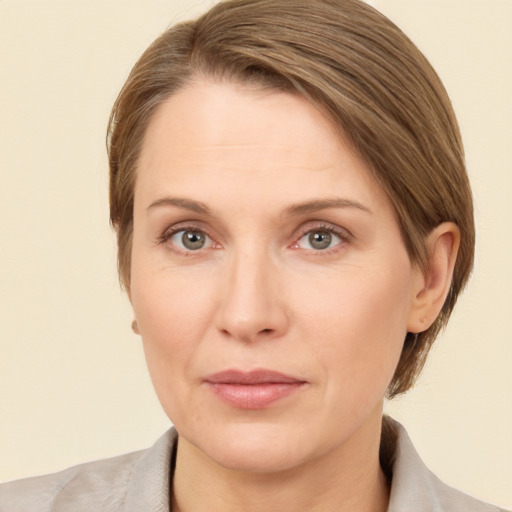 Joyful white adult female with medium  brown hair and grey eyes