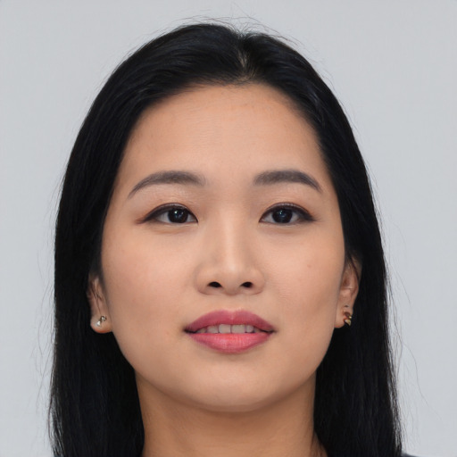 Joyful asian young-adult female with long  black hair and brown eyes