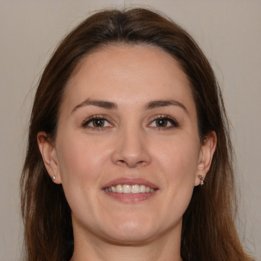 Joyful white adult female with medium  brown hair and brown eyes