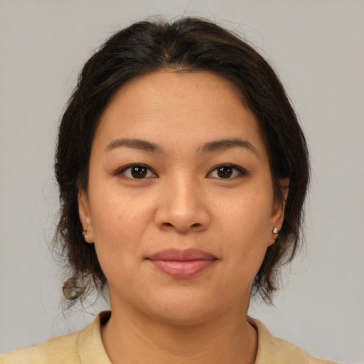 Joyful asian young-adult female with medium  brown hair and brown eyes