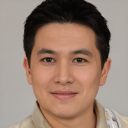 Joyful asian young-adult male with short  brown hair and brown eyes