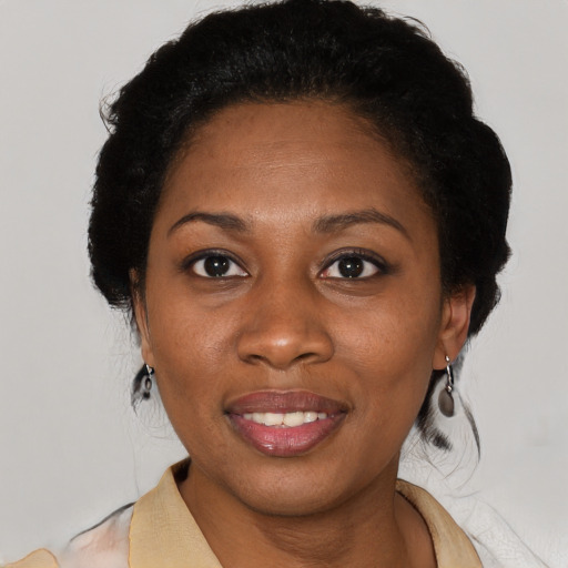 Joyful black adult female with medium  black hair and brown eyes