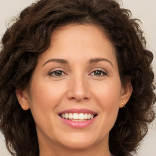 Joyful white young-adult female with long  brown hair and green eyes