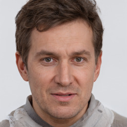 Joyful white adult male with short  brown hair and grey eyes