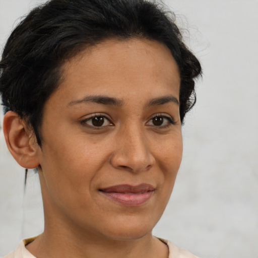 Joyful latino young-adult female with short  brown hair and brown eyes