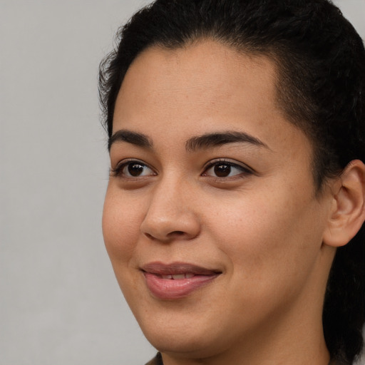 Joyful latino young-adult female with short  brown hair and brown eyes