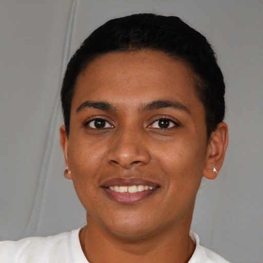 Joyful black young-adult female with short  black hair and brown eyes