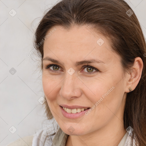 Joyful white adult female with medium  brown hair and brown eyes