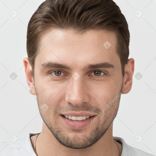 Joyful white young-adult male with short  brown hair and grey eyes