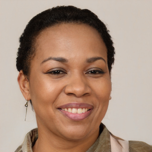Joyful black adult female with short  brown hair and brown eyes