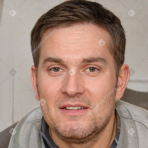 Joyful white adult male with short  brown hair and brown eyes