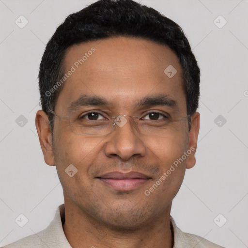 Joyful latino adult male with short  black hair and brown eyes