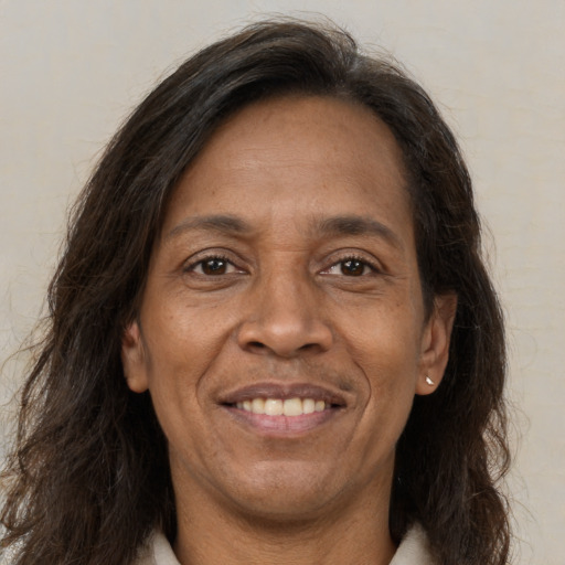 Joyful latino adult female with long  brown hair and brown eyes
