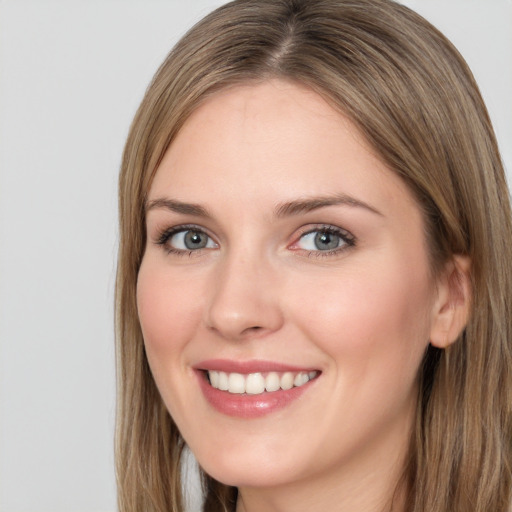 Joyful white young-adult female with long  brown hair and green eyes