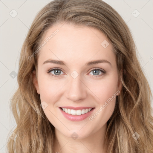 Joyful white young-adult female with long  brown hair and blue eyes