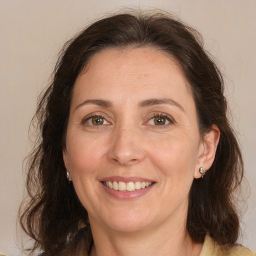 Joyful white adult female with medium  brown hair and brown eyes