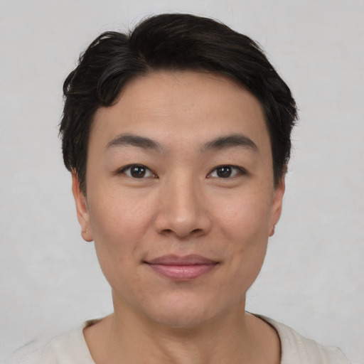 Joyful asian young-adult female with short  black hair and brown eyes