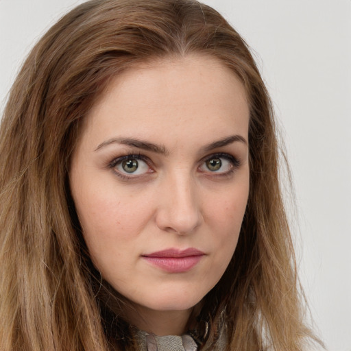 Joyful white young-adult female with long  brown hair and green eyes