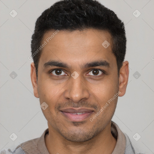 Joyful latino young-adult male with short  black hair and brown eyes