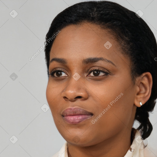 Joyful black young-adult female with short  black hair and brown eyes