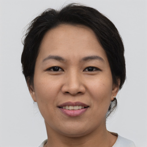 Joyful asian young-adult female with short  brown hair and brown eyes