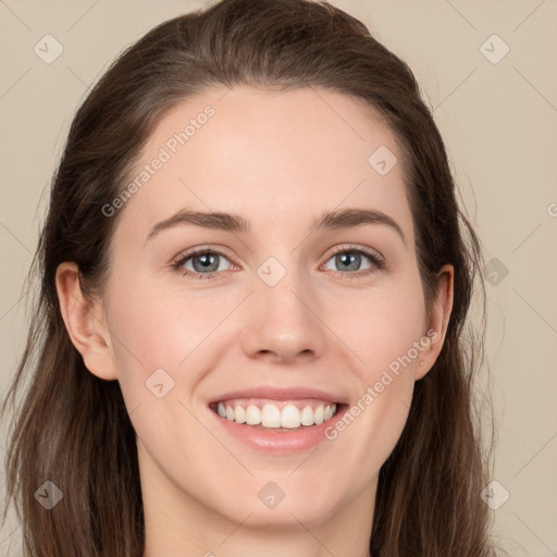 Joyful white young-adult female with long  brown hair and grey eyes