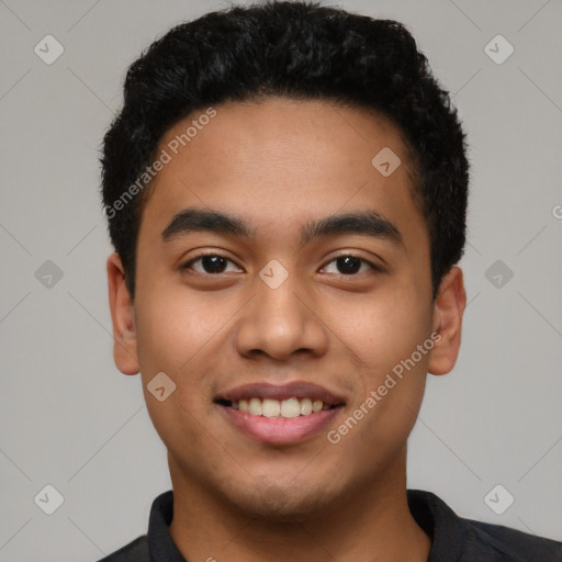 Joyful latino young-adult male with short  black hair and brown eyes