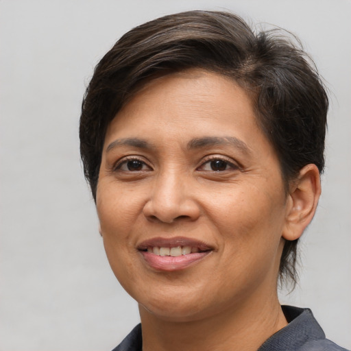 Joyful white adult female with short  brown hair and brown eyes