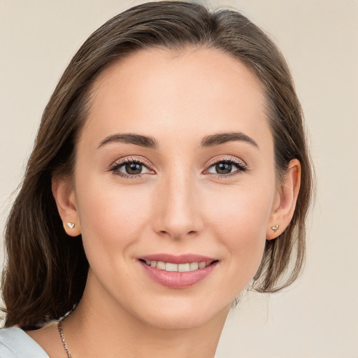 Joyful white young-adult female with medium  brown hair and blue eyes