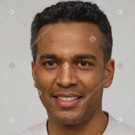 Joyful latino adult male with short  brown hair and brown eyes