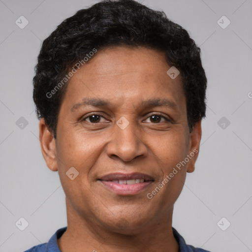 Joyful latino adult male with short  brown hair and brown eyes
