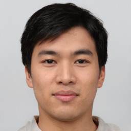 Joyful asian young-adult male with short  black hair and brown eyes