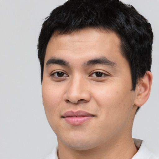 Joyful asian young-adult male with short  black hair and brown eyes