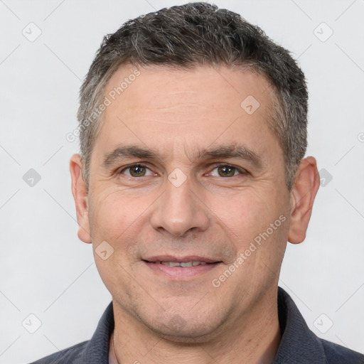 Joyful white adult male with short  brown hair and brown eyes