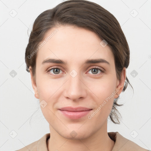 Joyful white young-adult female with medium  brown hair and grey eyes