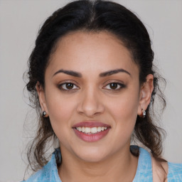 Joyful latino young-adult female with medium  brown hair and brown eyes