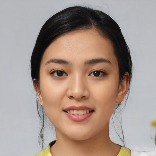Joyful asian young-adult female with medium  black hair and brown eyes