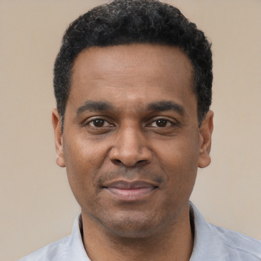 Joyful latino adult male with short  black hair and brown eyes