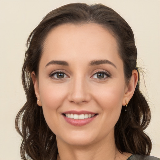 Joyful white young-adult female with long  brown hair and brown eyes