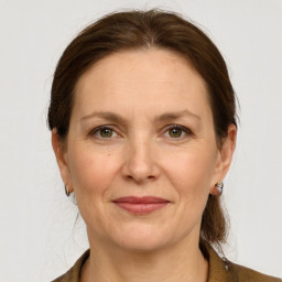 Joyful white adult female with medium  brown hair and grey eyes